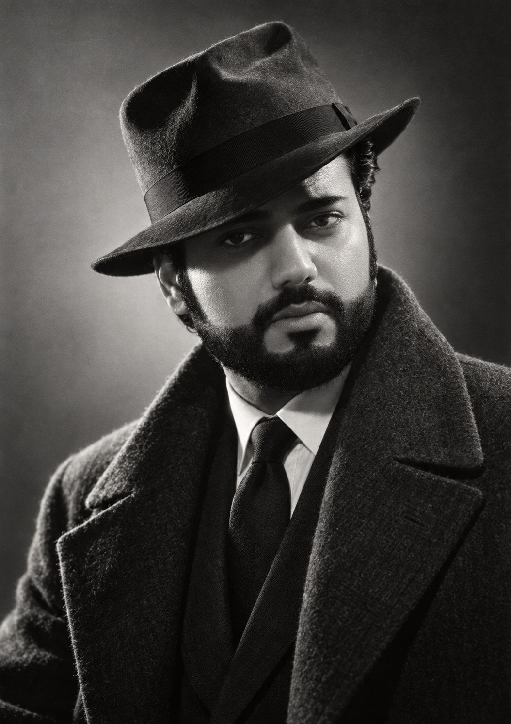 Manvedeep Singh in a fedora and overcoat
